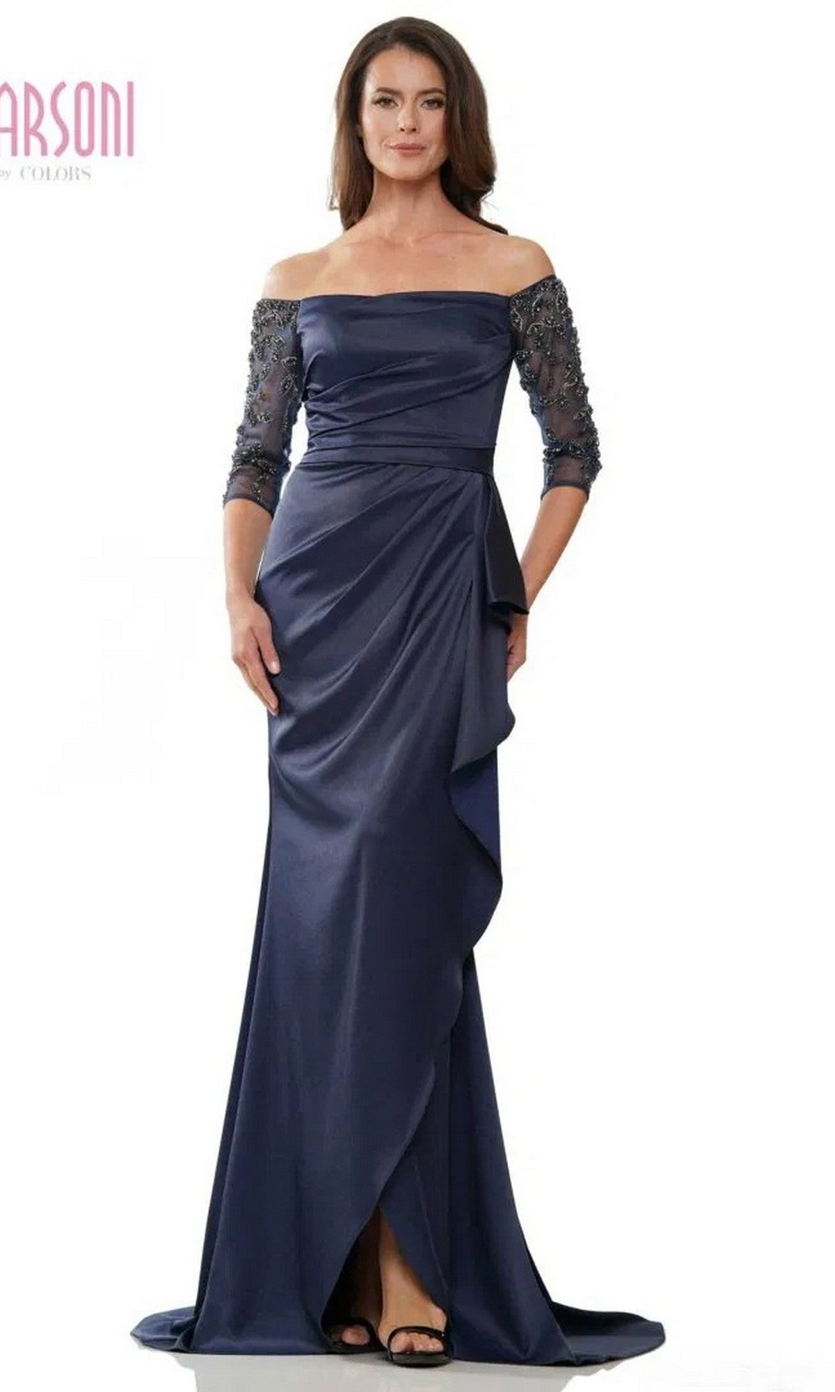 A woman stands facing forward in a navy Marsoni MV1254 long formal dress, featuring beaded three-quarter sleeves and a draped skirt.